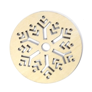 Laser-cut wooden Christmas coaster with snowflake hollow pattern on white background