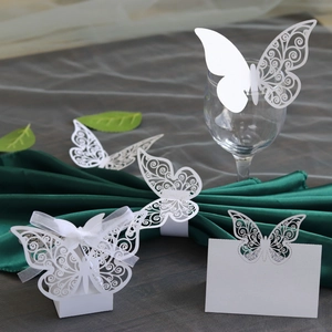 Laser-cut white butterfly paper set for wedding decor including napkin ring and place card