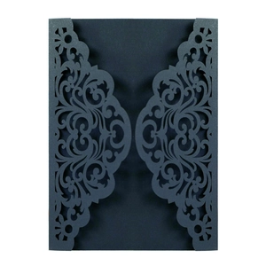Laser-cut deep blue invitation cover with elegant symmetrical floral vine patterns