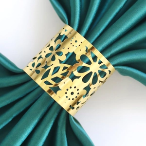 Golden laser-cut flower napkin ring with mirror finish for elegant party table decor