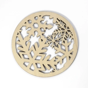 Laser cut wooden coaster with snowflake patterns in natural finish on white background