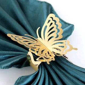 Detailed macro view of a golden butterfly napkin ring with hollowed wing design