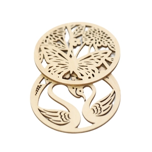 Laser cut wooden coasters featuring butterfly and swan heart designs for table decor