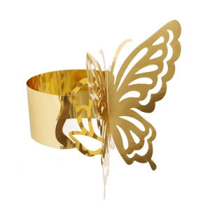 Macro shot of mirror-polished golden butterfly napkin ring with hollow wings detail