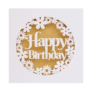 Detail of laser-cut white Happy Birthday card featuring hollow daisy patterns and gold foil