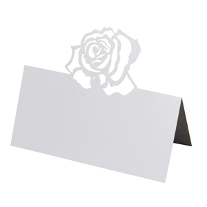 Elegant laser cut white pearl paper place card featuring intricate hollow rose flower design