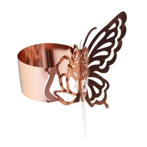 Detailed macro of laser-cut rose gold butterfly napkin ring with mirror finish texture