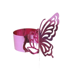 Detailed view of hollow butterfly napkin ring with shiny pink metallic finish