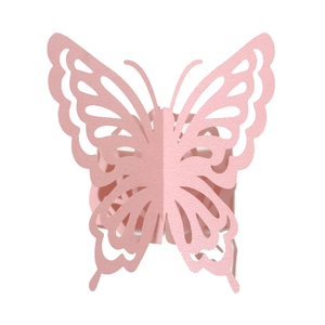 Detail of laser-cut pink butterfly napkin ring with delicate hollow wings texture