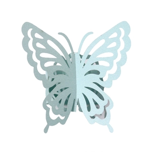 Detail of light blue laser-cut butterfly napkin ring with intricate 3D hollow pattern