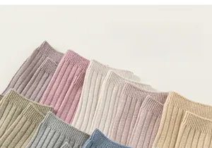 Macro shot of multi-color ribbed knit cotton socks showing detailed vertical stripe texture
