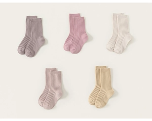 Detailed macro view of five pairs of ribbed cotton blend crew socks in Morandi tones