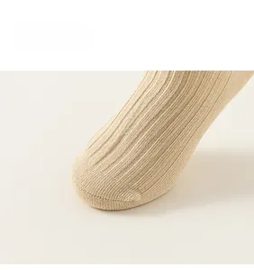 Close-up of ribbed knit cotton sock toe with seamless stitching in beige color