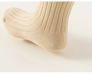 Detail shot of khaki knit ribbed socks showing high-elastic texture and seamless heel stitching