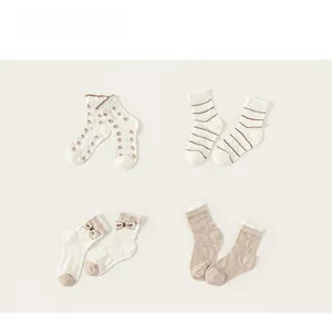 Détail de quatre paires de chaussettes hautes en résille avec dentelle et nœuds