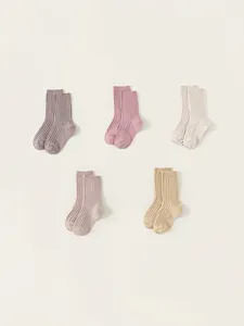 Five pairs of girls' ribbed cotton crew socks in assorted soft pastel and earth tones