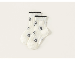 Vue détaillée des chaussettes en maille de coton avec bordure volantée et motifs roses