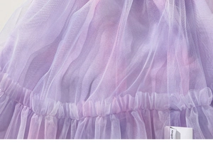 Vue détaillée du tissu en tulle violet à plusieurs niveaux avec volants et effet dégradé