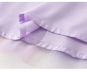 Détail macro de l'ourlet lavande avec coutures précises et couches de tulle blanc