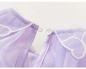 Détail de l'encolure dos d'une robe de fée pour fille avec broderie coeur et bouton
