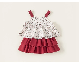 Detail of red floral print top and layered ruffle cake skirt for girl's summer outfit