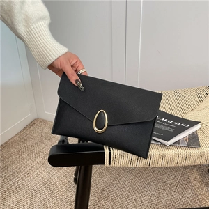 Women's black Saffiano leather envelope clutch with golden oval metal buckle closure