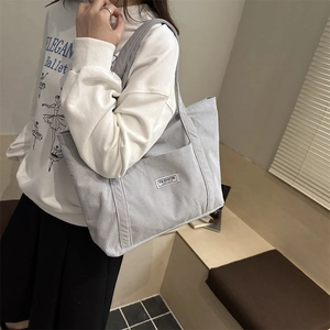 Minimalist light blue corduroy tote bag for women featuring a textured stripe design