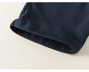 Dettaglio delle cuciture precise e della trama liscia in blu navy del completo estivo