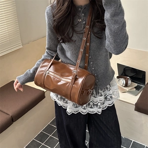 Vintage brown leather Boston bag with metal eyelet strap for women's daily commute