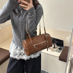 Retro brown leather cylindrical tote bag with silver zippers and double shoulder straps
