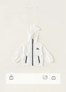 Detail of white children's sun protection jacket with hood and mountain logo texture