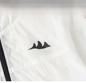 Detail of white lightweight kids jacket with black mountain print and quality zipper