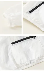 Detail of white sun protection jacket showing elastic cuffs and black zipper pocket