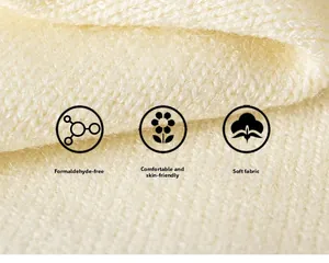 Detail macro of cream knitted fabric showing thick soft texture and skin-friendly material