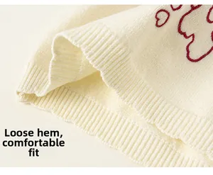 Detailed macro view of the knitted rib hem with red cloud pattern and loose fit design