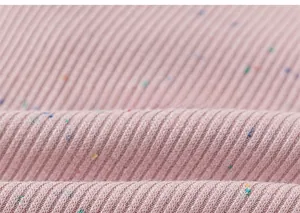 Macro shot of soft pink ribbed knit cotton fabric with colorful rainbow nep texture