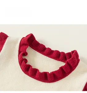 Detail of red ruffle neckline with contrasting knit textures on kids sweater vest