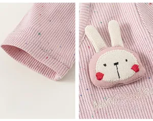 Close-up of pink toddler top featuring ribbed fabric with dots and 3D bunny ornament