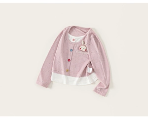 Detail of girls' long sleeve top featuring faux two-piece design and cute bunny patch