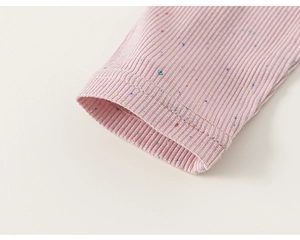 Close-up of pink ribbed fabric cuffs with colorful speckle detail and neat stitching