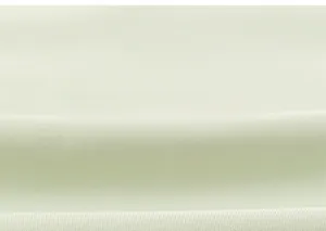 Gros plan sur la texture du tissu en coton vert clair respirant pour pantalon d'été