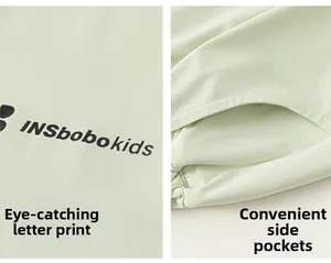 Détail du pantalon enfant vert menthe avec imprimé lettres et poches latérales