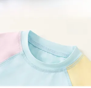 Close-up of classic crew neck and pastel patchwork design on kid's summer top