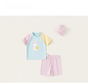 Detailed view of children's swimwear set with cute bunny print and pastel color blocking