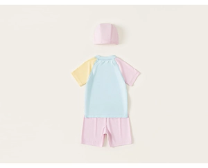 Flat lay of kids three-piece swimwear set with colorful color-blocking short sleeve top