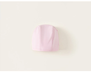 Detail of pink knitted children's swim cap with elastic fabric and double-stitched hem
