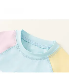 Close-up of contrast stitching on pastel colorblock kids sleeveless top with smooth seams