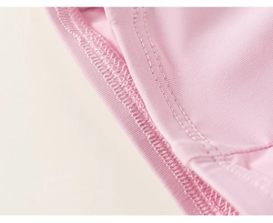 Detailed macro view of high-quality double-needle stitching on light pink knitted fabric