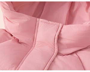 Detailed close-up of pink hooded winter down jacket with premium stitching and matte fabric