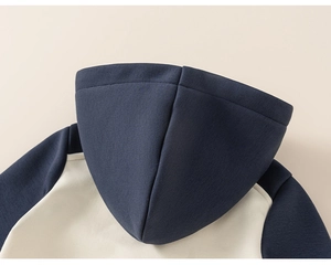 Detail of the contrasting navy and cream hoodie hood and high-quality knit fabric texture